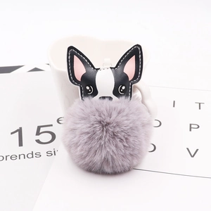 Detail of a gray faux fur bulldog pompom keychain with premium PU leather dog head charms