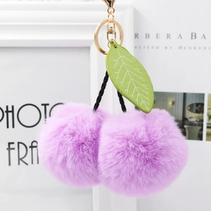 Purple cherry faux fur keychain accessory with golden ring and green leather leaf detail
