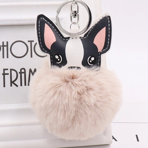 Cute black and white puppy PU leather keychain with a beige faux fur pompom ball charm