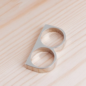 Close-up of polished silver double-finger ring with letter B design and metallic shine