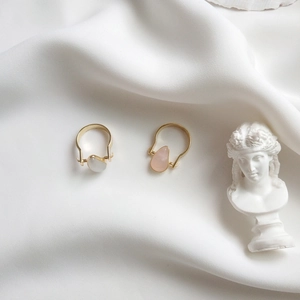 Detailed shot of 925 silver rings with teardrop cat eye stones on silk background