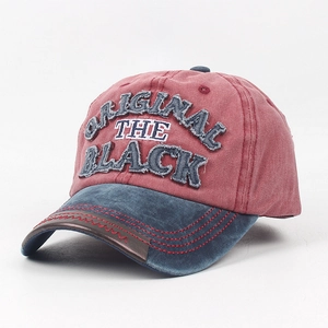 Detailed close-up of embroidery patches and leather trim on a vintage baseball cap