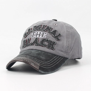 Detail of washed cotton baseball cap featuring vintage embroidery and distressed brim