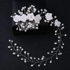 Detail of bridal hair comb and headband set with white roses, pearls, and rhinestones