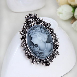 Vintage relief brooch with female cameo and sparkling crystals on heart ceramic base