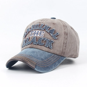 Detail of vintage washed baseball cap with contrast brim and leather piping edge