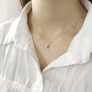 Close-up of a 925 sterling silver gold necklace with a pink marquise zircon pendant