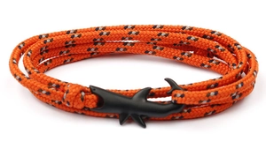 Detail of shark buckle on orange woven cord bracelet with matte black finish shark head