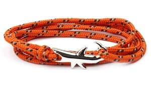 Macro shot of a woven nylon nautical bracelet with a silver-tone shark-shaped metal buckle