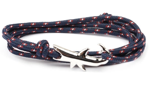 Detail of nautical shark tail clasp with navy blue and red-white woven rope bracelet