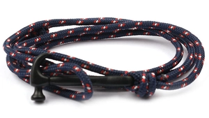 Detail of navy braided anchor bracelet featuring a black matte shark horn hammer clasp