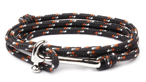 Detail of woven paracord bracelet with silver hammerhead shark clasp and orange accents