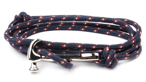 Detail of nautical braided rope bracelet with silver hammer shackle closure in blue and red