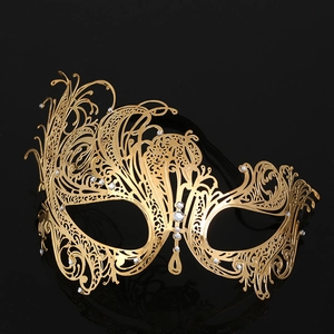 Detailed close-up of golden metal filigree mask with sparkling rhinestone embellishments