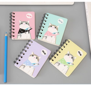 Detailed view of four A7 spiral notebooks featuring cute cartoon cat patterns in pastel colors