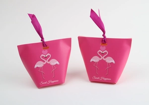 Detail of pink flamingo gift bags with sweet happiness text and matching silk ribbons