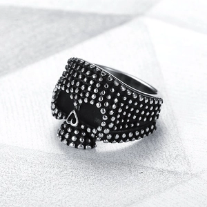Macro detail of retro skull ring with silver black finish and punk rock bead texture