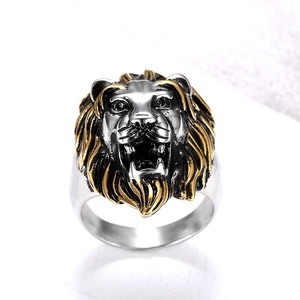 Detailed close-up of a two-tone lion head ring with gold and silver vintage carving