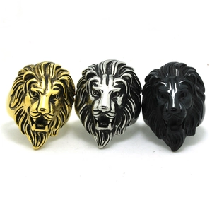 Detailed view of three lion head rings in gold, silver, and matte black finishes
