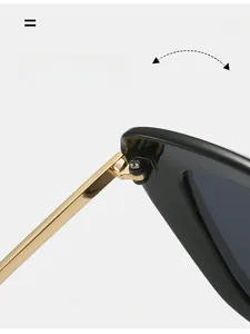 Close-up of durable golden metal hinges and black frame of trendy cat eye sunglasses