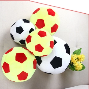 Detail shot of plush soccer pillows in various sizes and dual-color combinations