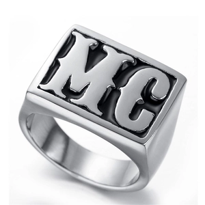 Macro shot of silver stainless steel signet ring with embossed MC letters on square face