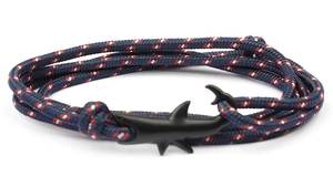 Detail showing navy woven nautical rope bracelet with matte black shark shaped hook clasp