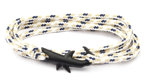 Detail of nautical braided bracelet with matte black shark-shaped clasp in three-tone weave