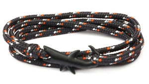 Detail of multi-layer woven bracelet with matte black shark hook and orange accents