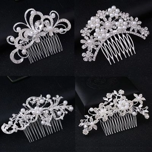 Detail of four silver bridal hair combs with intricate rhinestones and faux pearls