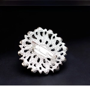 Macro shot showing the back of the silver brooch with its horizontal pin fastener detail