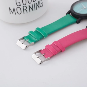 Detailed close-up of premium leather watch straps in vibrant green and rose red finishes