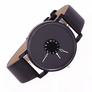 Close-up of minimalist black quartz watch featuring a unique central number dial design