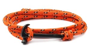 Close-up of bright orange braided anchor bracelet with black metal hammer-style buckle