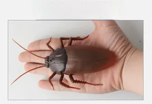 Realistic large size infrared remote control cockroach toy held in hand for size comparison