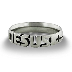 Close-up of silver stainless steel coffin ring with Jesus engraving and cross symbol