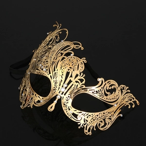 Macro detail of golden metal masquerade mask featuring laser-cut patterns and rhinestones