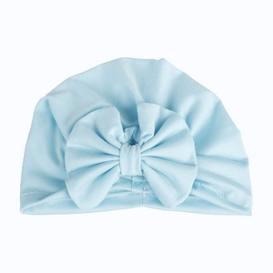 Detailed view of soft light blue cotton baby turban hat with a large decorative bow