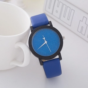 Macro shot of star-blue glitter dial and blue textured leather strap on a minimal watch