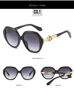 Detailed side view of oval sunglasses featuring gold geometric hollow temples and dark lenses