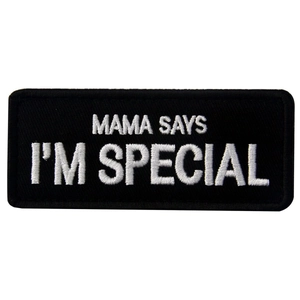 Close-up of black rectangular patch with white embroidered MAMA SAYS I'M SPECIAL text