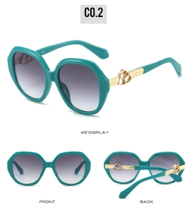 Detail of dark teal oval sunglasses with luxury gold metal textured temples and logo