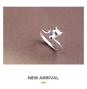 Detail of a silver adjustable cat ring showing the minimalist animal ears and tail design