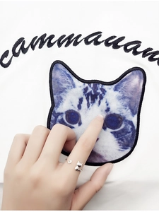 Detail shot of a silver cat open ring showing the creative 3D kitty head and tail