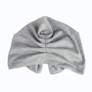 Detail view of light grey cotton baby turban hat with decorative knot and soft knit texture