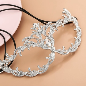 Macro detail of bridal rhinestone spiderweb mask with sparkling silver crystals