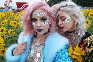 Close-up of sparkling acrylic face jewels and body glitter for festival makeup