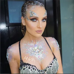 Macro detail of iridescent face jewels and glitter on skin for festive party makeup