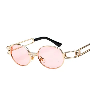 Retro steampunk round sunglasses with gold metal frame and pink lenses at a 45-degree angle