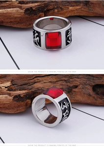 Detailed macro view of men's titanium ring with red gemstone and engraved characters